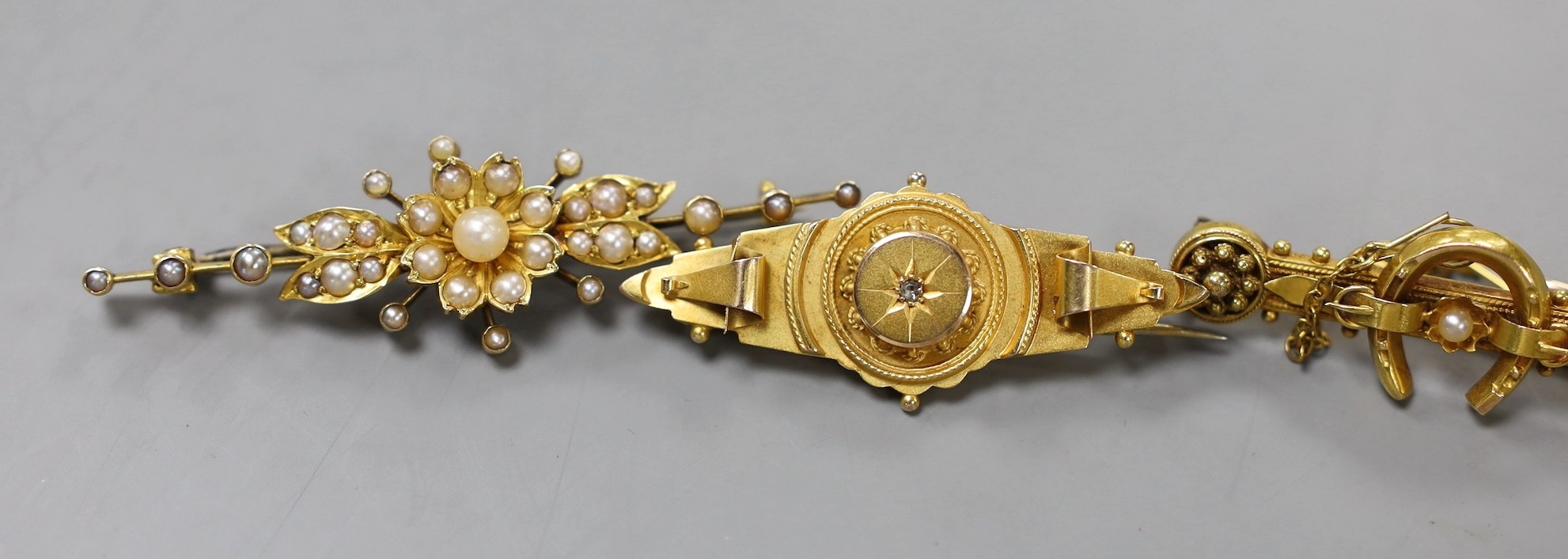Two early 20th century 9ct and gem set bar brooches, gross weight 4.7 grams, a similar 15ct horseshoe bar brooch, gross 3.4 grams, two other yellow metal and gem set bar brooches, gross 10 grams, a 22ct gold and white op